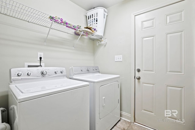 laundry room with light tile patterned floors and washing machine and dryer