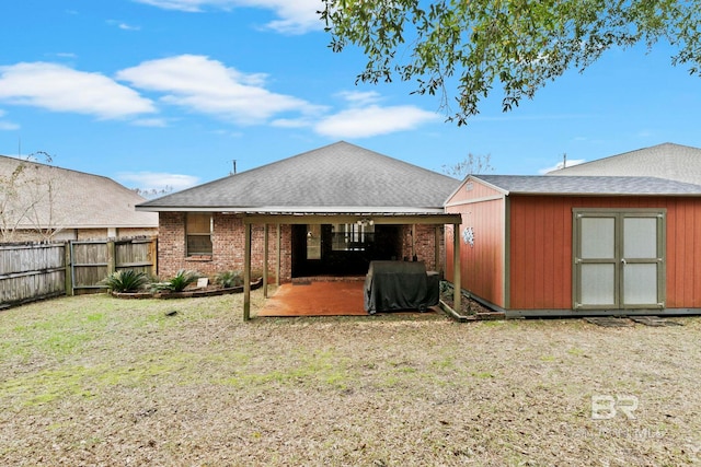 rear view of house featuring a patio, a shed, and a lawn