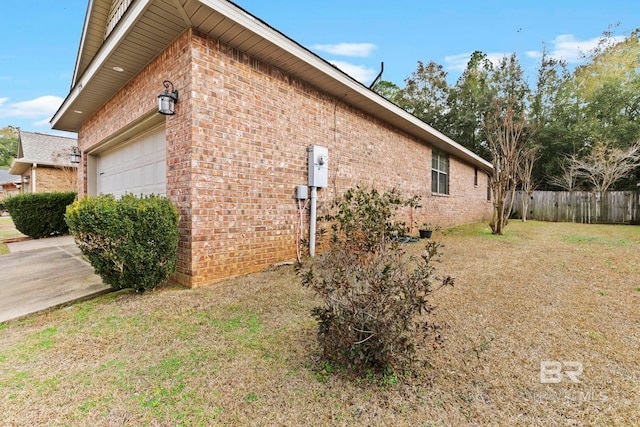 view of home's exterior with a garage and a yard