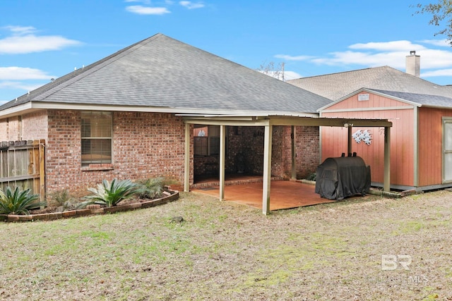 rear view of house featuring a patio and a lawn