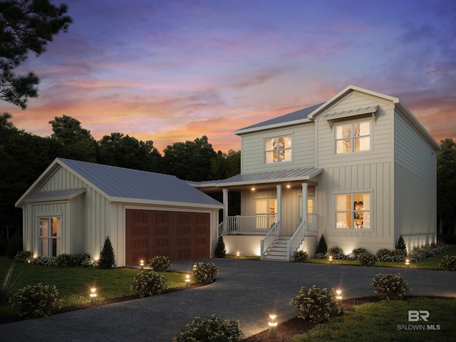 view of front of home with a garage and a porch