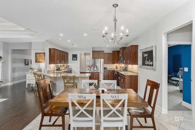 dining room featuring visible vents, baseboards, light wood-type flooring, recessed lighting, and an inviting chandelier