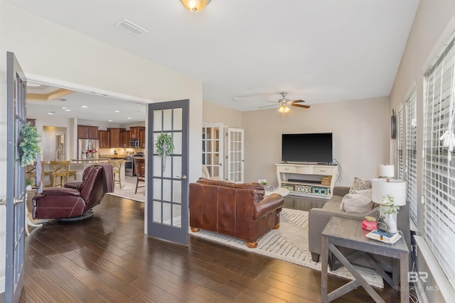 living room with a ceiling fan, visible vents, recessed lighting, dark wood-style flooring, and french doors