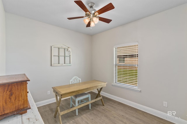 home office featuring ceiling fan, baseboards, and wood finished floors