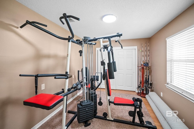 workout room featuring a textured ceiling