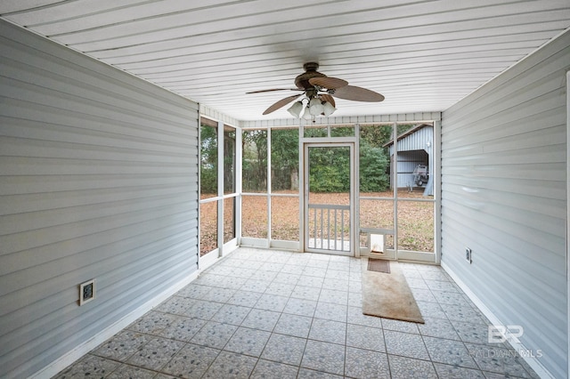 unfurnished sunroom with ceiling fan