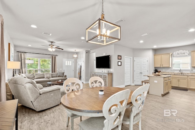 dining space featuring ceiling fan with notable chandelier, light wood-style flooring, visible vents, and recessed lighting