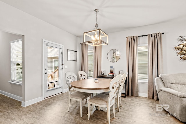 dining space featuring light wood-type flooring, a healthy amount of sunlight, and baseboards