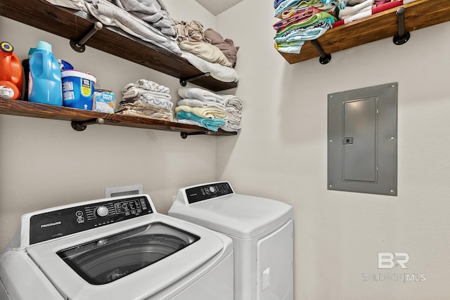 washroom with washing machine and dryer, laundry area, and electric panel