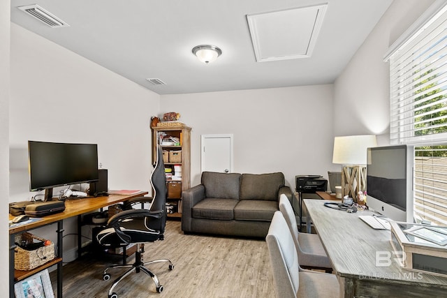 office area featuring wood finished floors and visible vents