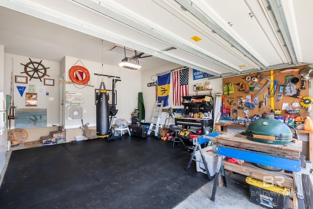 garage featuring a garage door opener and a workshop area