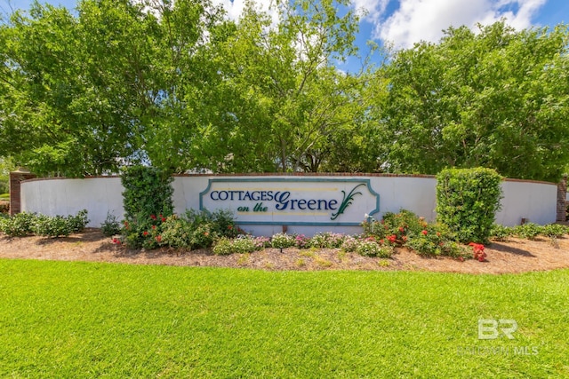 community / neighborhood sign with a lawn