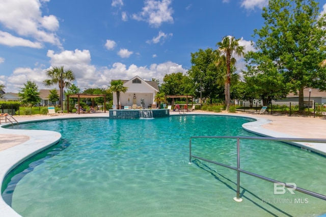 community pool featuring a patio area, fence, and a pergola