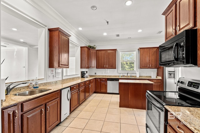 kitchen featuring light tile patterned floors, stainless steel appliances, ornamental molding, and a sink