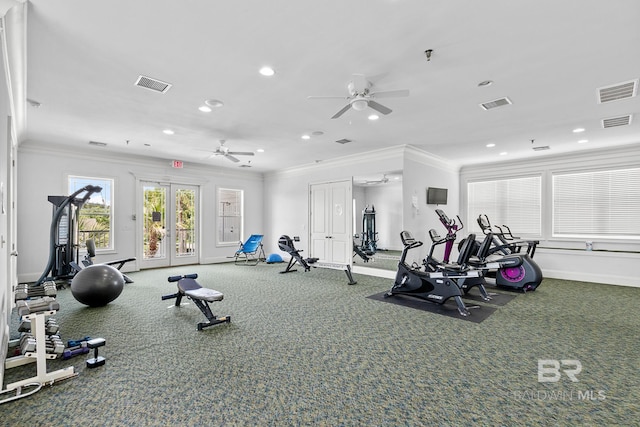 gym with baseboards, visible vents, and crown molding