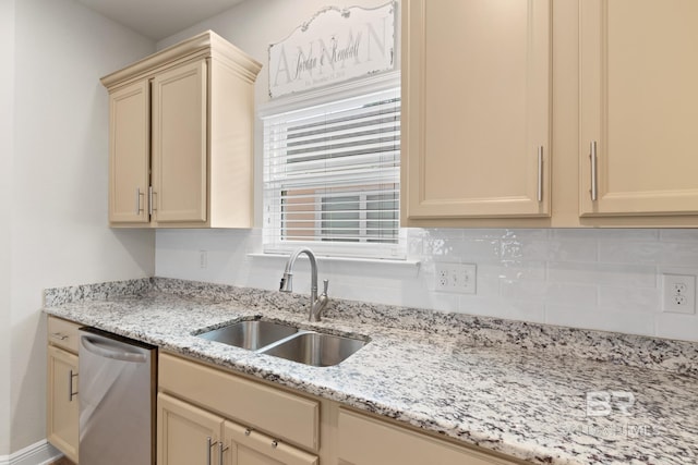 kitchen featuring a sink, cream cabinetry, light stone countertops, dishwasher, and tasteful backsplash