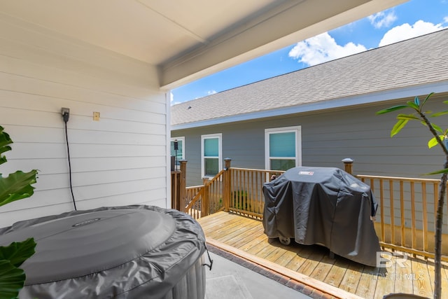 wooden terrace featuring a grill