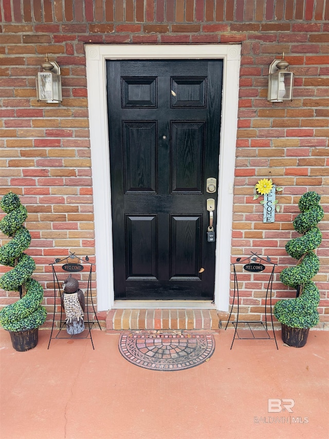 entrance to property with brick siding