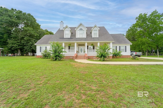 cape cod-style house featuring a front yard and covered porch