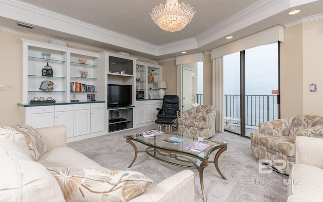 carpeted living room featuring a textured ceiling, crown molding, and an inviting chandelier