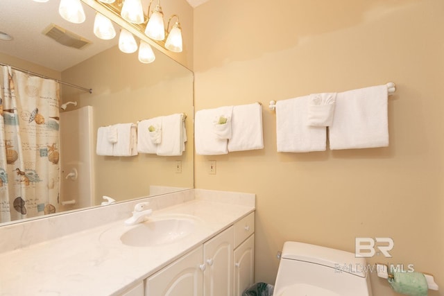 bathroom featuring oversized vanity, toilet, and a textured ceiling