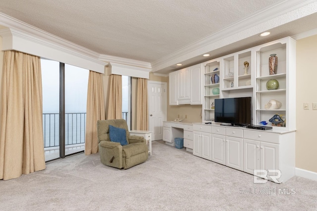 sitting room featuring light colored carpet, a textured ceiling, and crown molding