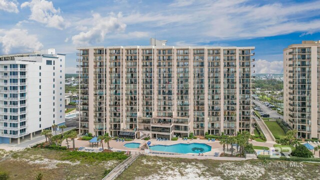 view of building exterior featuring a community pool