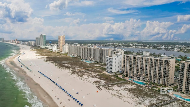 drone / aerial view with a water view and a beach view