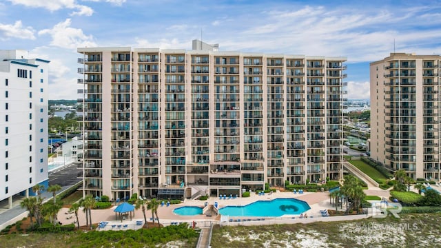 view of building exterior featuring a community pool