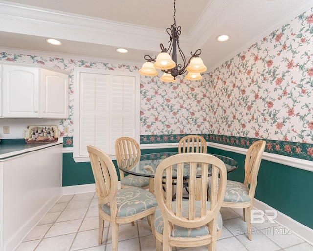 dining space with a chandelier, crown molding, light tile floors, and a tray ceiling