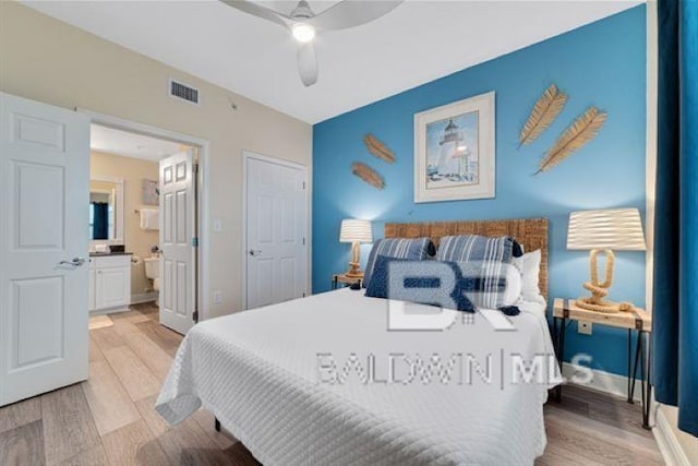 bedroom with visible vents, connected bathroom, ceiling fan, light wood-type flooring, and baseboards