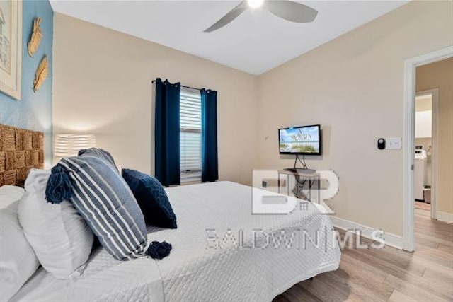 bedroom with wood finished floors, a ceiling fan, and baseboards