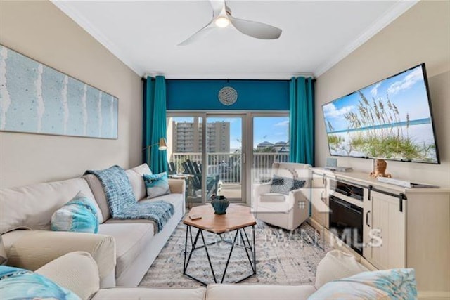 living area with ceiling fan and ornamental molding