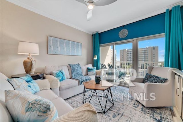 living area featuring ceiling fan, ornamental molding, wood finished floors, and a city view