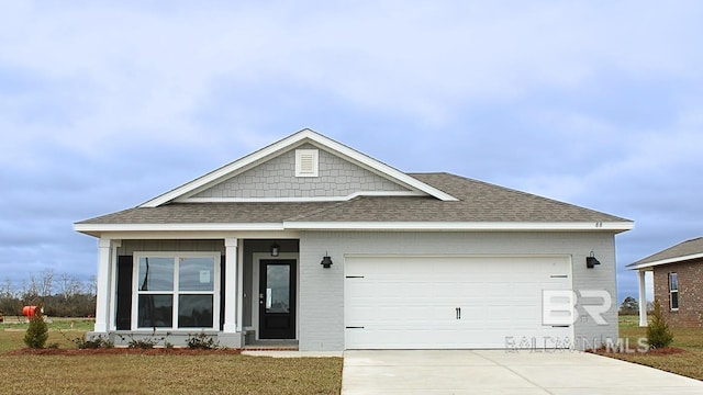 8859 Chabo Cir, Foley, AL 36580 - view of front facade featuring roof with shingles, driveway, an attached garage, and brick siding