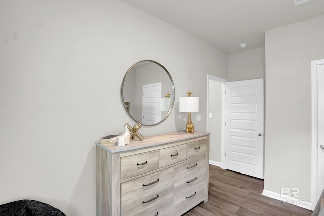 bedroom with dark hardwood / wood-style floors