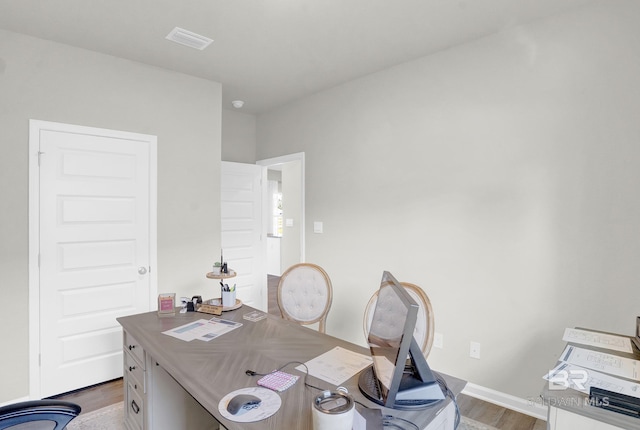 home office with hardwood / wood-style floors