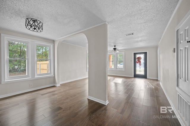 entrance foyer with a textured ceiling, a wealth of natural light, ceiling fan, and dark hardwood / wood-style floors