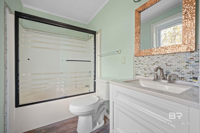 full bathroom with tasteful backsplash, crown molding, wood-type flooring, combined bath / shower with glass door, and vanity