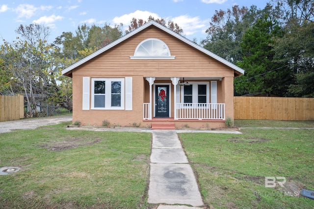 bungalow-style house with covered porch and a front yard