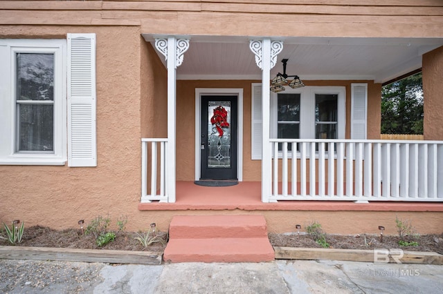 entrance to property featuring a porch