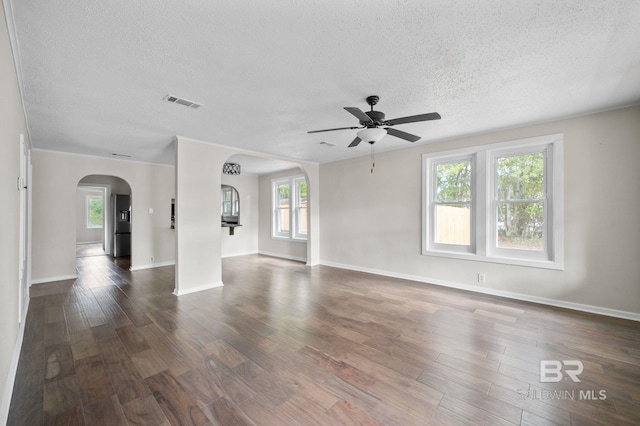 unfurnished room featuring ceiling fan, dark hardwood / wood-style flooring, and a textured ceiling