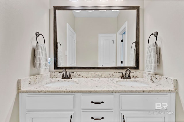 full bath with double vanity and a sink