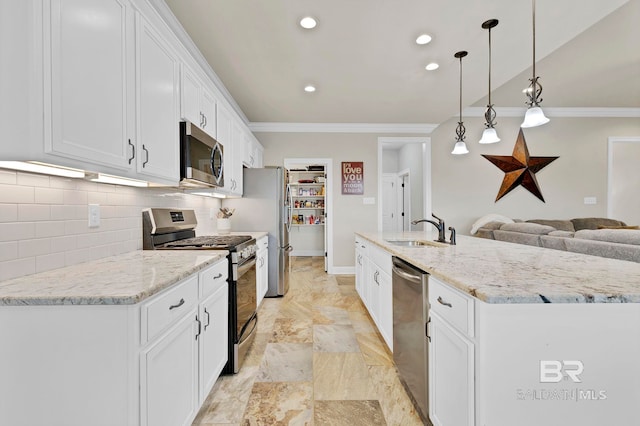 kitchen featuring a sink, white cabinetry, appliances with stainless steel finishes, tasteful backsplash, and crown molding