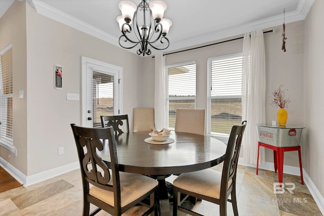 dining area with a wealth of natural light, crown molding, baseboards, and an inviting chandelier