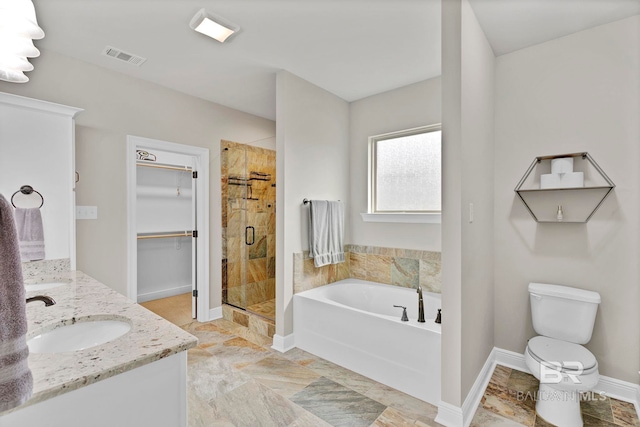 bathroom featuring visible vents, a sink, a walk in closet, a shower stall, and a bath