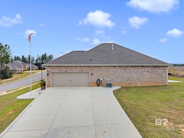 view of home's exterior with brick siding, a shingled roof, a lawn, an attached garage, and driveway