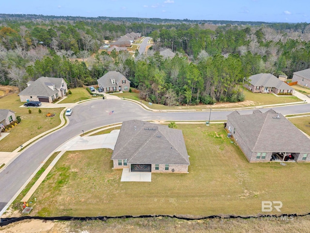 aerial view featuring a residential view and a wooded view