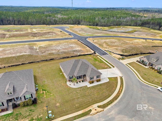 drone / aerial view featuring a view of trees