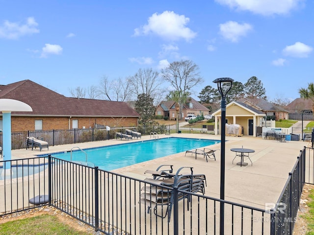 pool featuring a patio area and fence